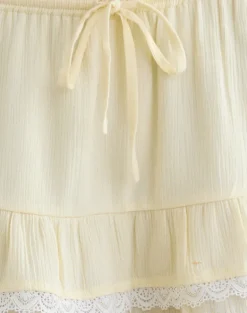 Yasu Ruffle Hem Mini Skirt in Crinkle Butter Yellow